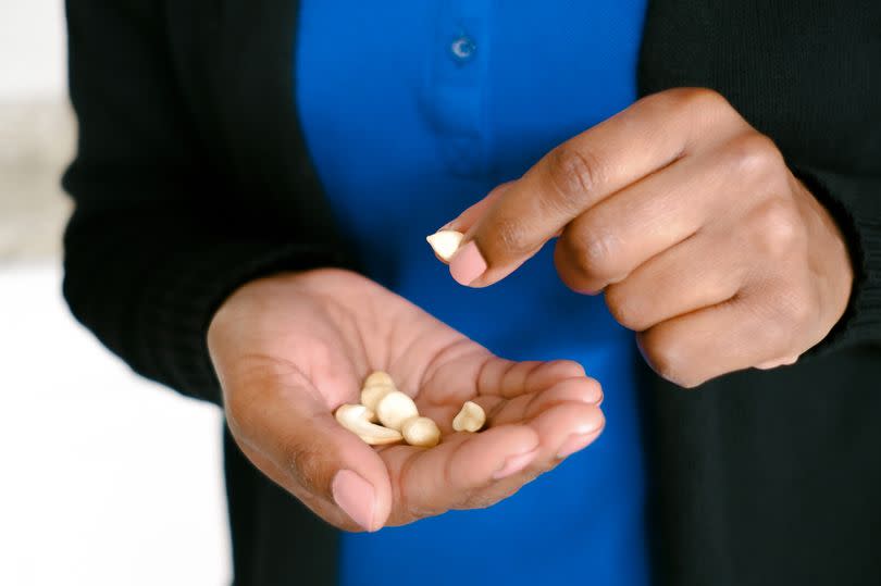 Close-up of unrecognizable black woman holding assorted nuts in hands