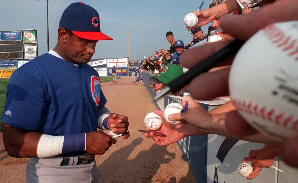 Chicago Cubs player Sammy Sosa signs autographs before exhibition game with the Iowa Cubs at Principal Park.