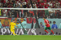 Spain's goalkeeper Unai Simon, left, fails to save the last shoot by Morocco's Achraf Hakimi at the penalties shoot out at the World Cup round of 16 soccer match between Morocco and Spain, at the Education City Stadium in Al Rayyan, Qatar, Tuesday, Dec. 6, 2022. (AP Photo/Julio Cortez)