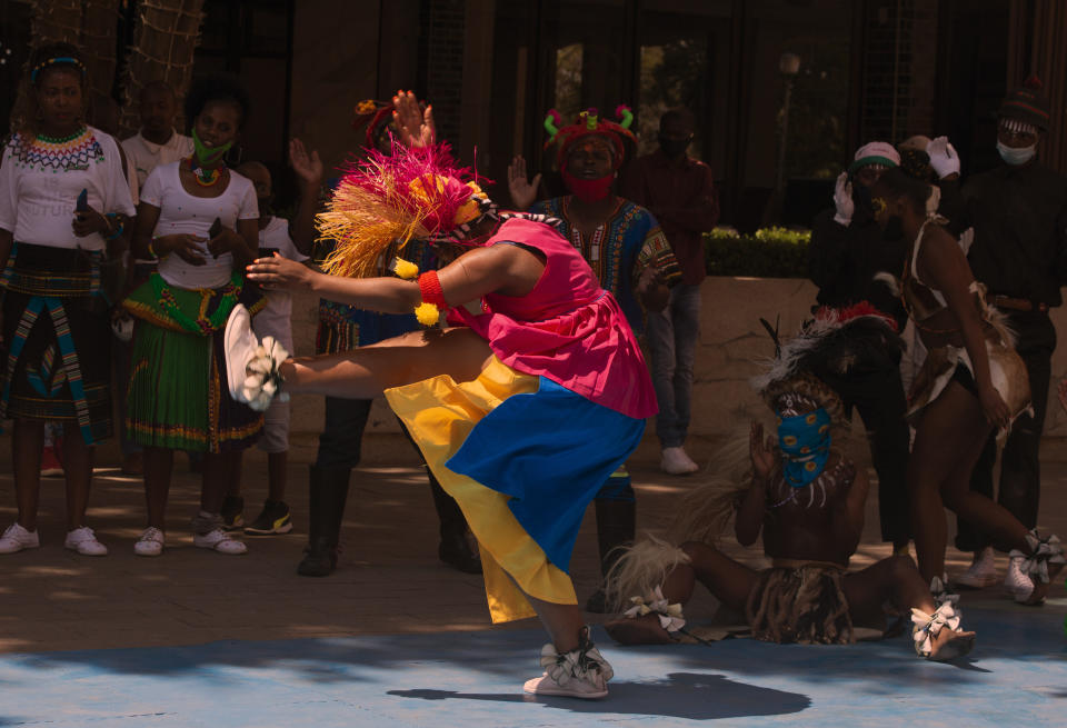 South Africans celebrate Heritage Day with song and dance at the Nelson Mandela Square in Johannesburg Thursday, Sept. 24, 2020. (AP Photo/Denis Farrell)