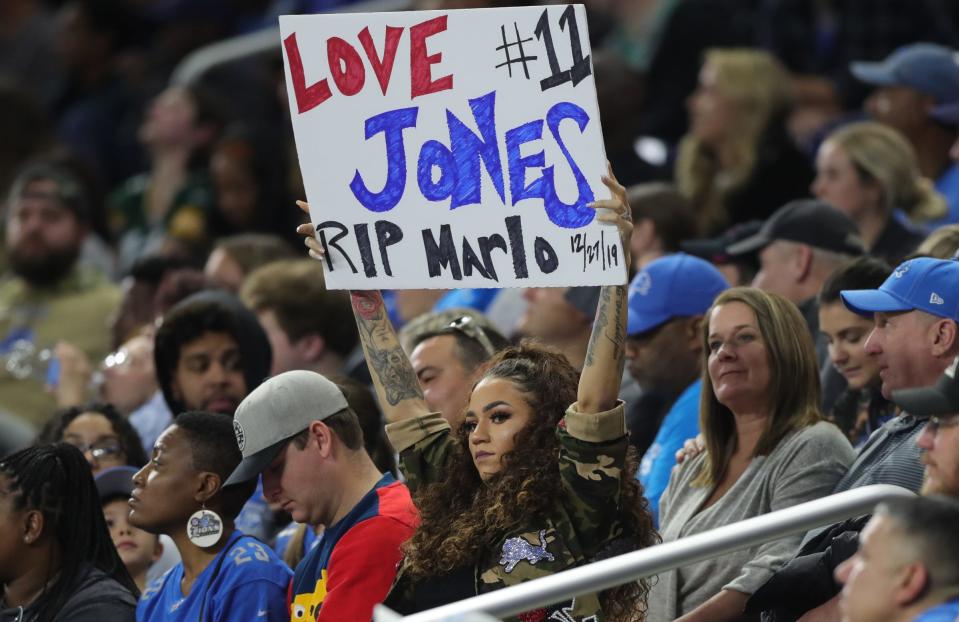 Jennifer Slay, wife of Detroit Lions cornerback Darius Slay, holds up a sign supporting receiver Marvin Jones, who infant son Marlo recently died, Sunday, Dec. 29, 2019 at Ford Field.