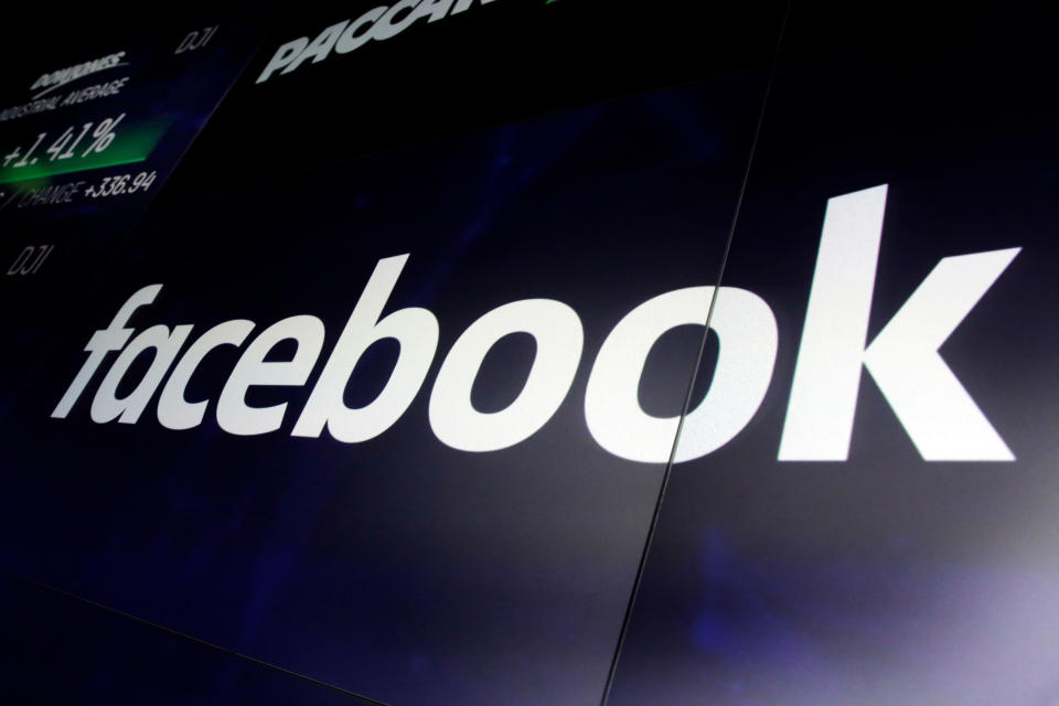 In this March 29, 2018, photo, the logo for Facebook appears on screens at the Nasdaq MarketSite, in New York's Times Square. New Zealand’s official privacy watchdog has described Facebook as “morally bankrupt” and suggested his country follow neighboring Australia’s lead by making laws that could jail executives over streamed violence such as the Christchurch mosque shootings. (AP Photo/Richard Drew, File)