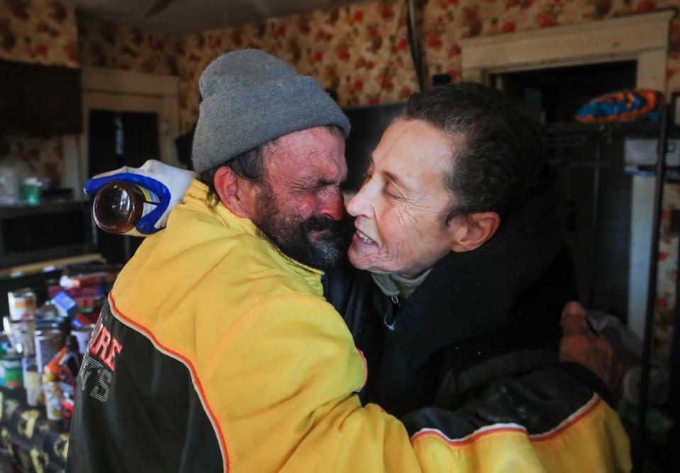 A tearful Danny Curd hugs friend Shirley Poole while visiting her at her Mayfield home Sunday morning as she attempts to go through the destroyed house.  Dec. 12, 2021