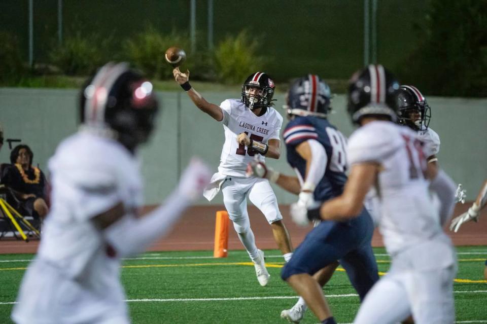 Laguna Creek Cardinals quarterback Mitchell Labrado (15) passes the ball to wide receiver Ryan Eddy (18) in the second half of the game against the Pleasant Grove Eagles on Friday, Sept. 8, 2023, at Sheldon High School.