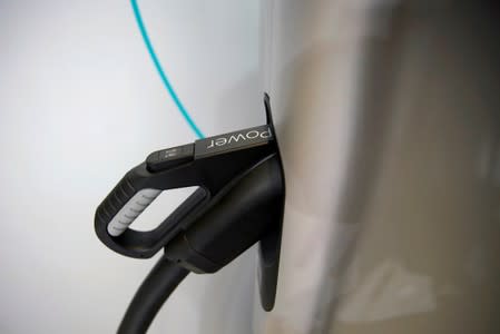 FILE PHOTO: Charging plug is seen on an electric vehicle (EV) at the second media day for the Shanghai auto show in Shanghai