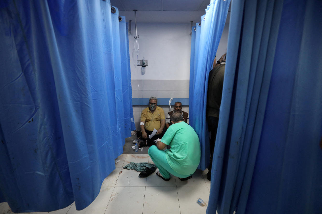 People are assisted at Shifa Hospital after hundreds of Palestinians were killed in a blast at Al-Ahli hospital in Gaza that Israeli and Palestinian officials blamed on each other in Gaza City, Gaza Strip, October 17, 2023. REUTERS/Mohammed Al-Masri REFILE - CORRECTING ATTRIBUTION OF CAUSE OF BLAST FROM 
