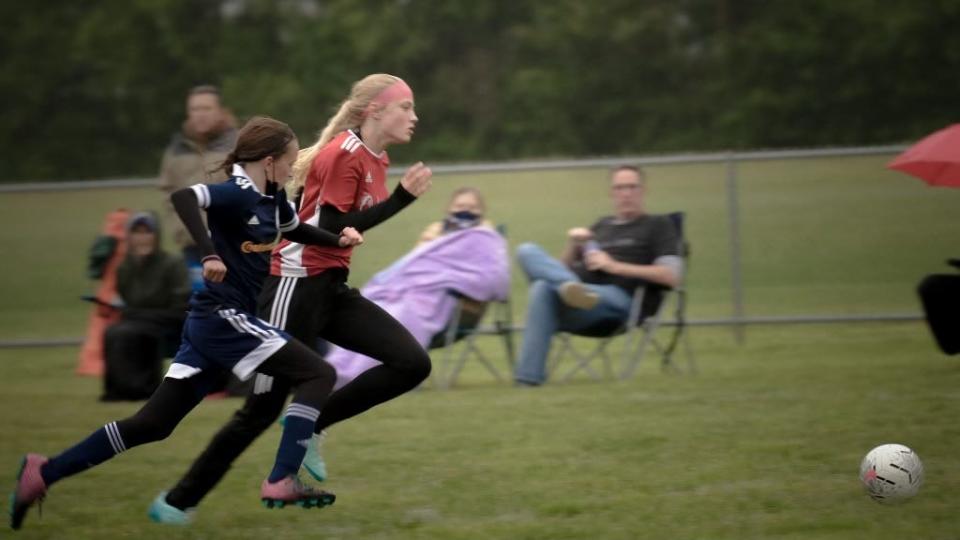 Lily Crawford, right, from the Pekin Pride U13 girls team races an opponent for the ball during a game in the 2021 Kickoff to Summer Classic tournament.