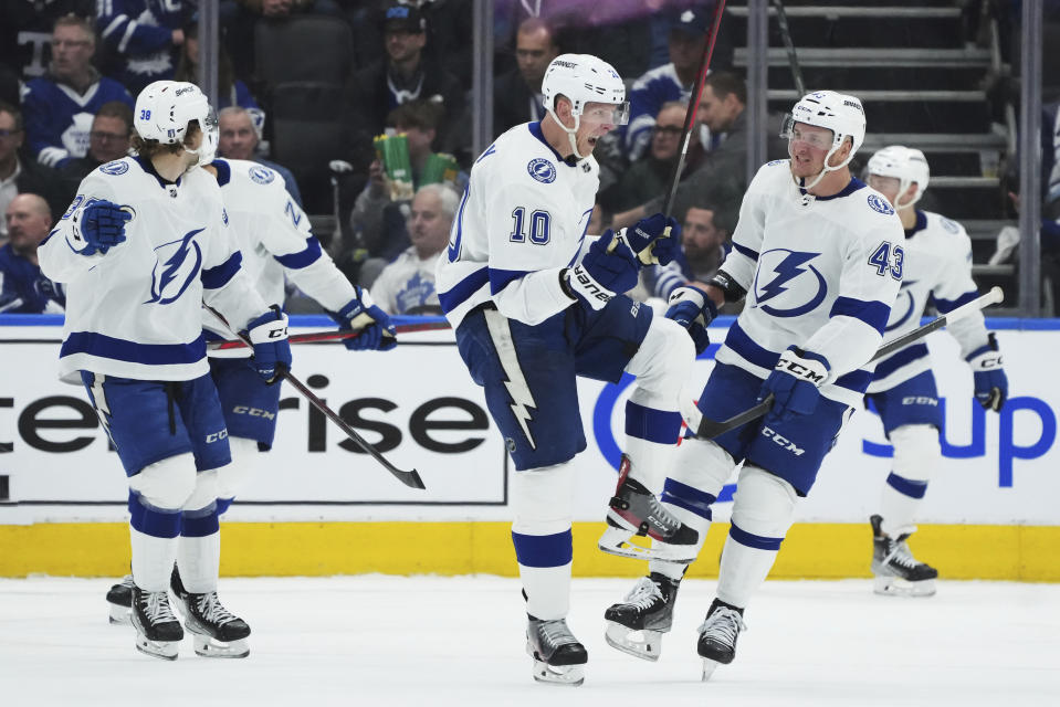 Tampa Bay Lightning right wing Corey Perry (10) celebrates his goal against the Toronto Maple Leafs with defenseman Darren Raddysh (43) during the second period of Game 1 of a first-round NHL hockey playoff series Tuesday, April 18, 2023, in Toronto. (Nathan Denette/The Canadian Press via AP)