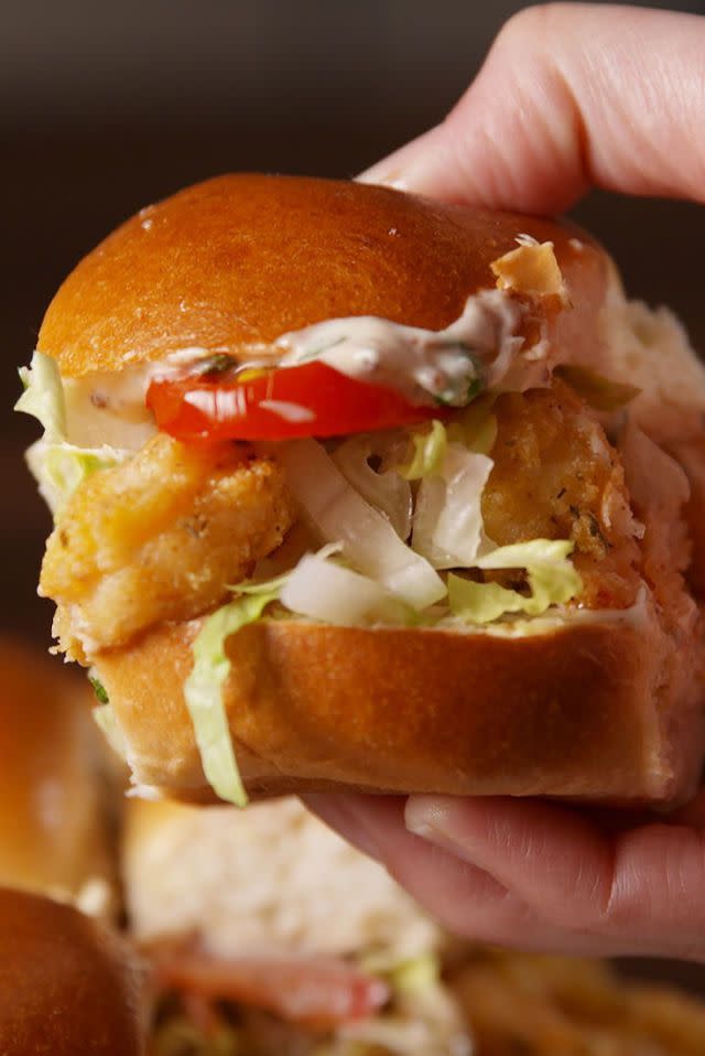 <p>Celebrate Mardi Gras the right way — with cornmeal-crusted fried shrimp sandwiched between buttery slider buns.</p><p>Get the <strong><a href="https://www.delish.com/cooking/videos/a51284/shrimp-po-boy-sliders-video/" rel="nofollow noopener" target="_blank" data-ylk="slk:Shrimp Po' Boy Sliders recipe;elm:context_link;itc:0" class="link ">Shrimp Po' Boy Sliders recipe</a> </strong>from Delish.  </p>