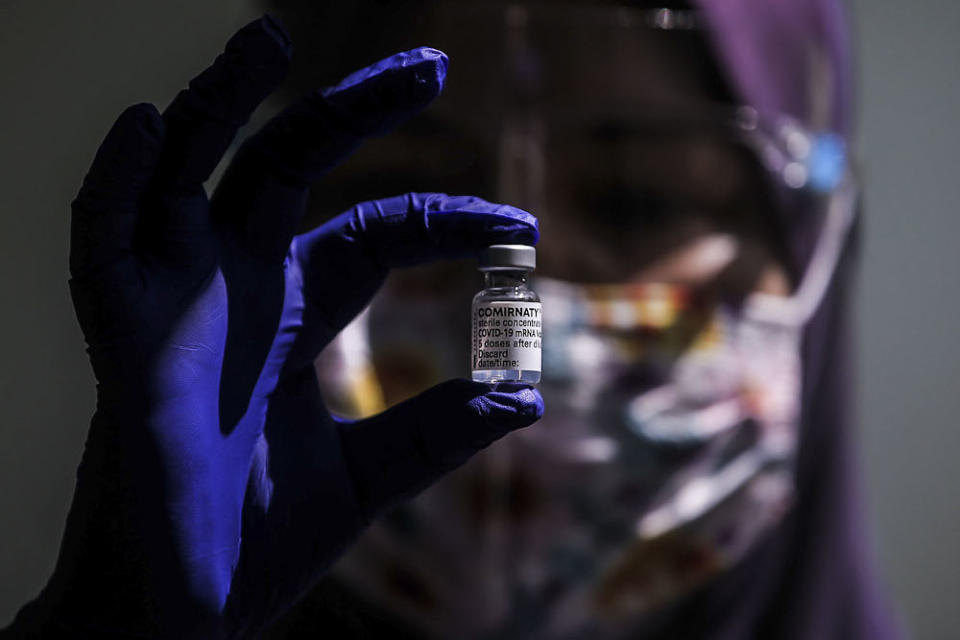 A healthcare worker holds a vial of the Pfizer-BioNTech Covid-19 vaccine at the UiTM Private Specialist Centre in Sungai Buloh March 2, 2021. ― Picture by Hari Anggara