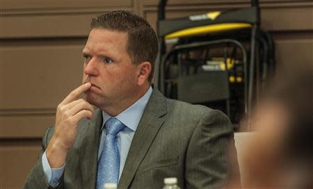 Former Fullerton police officer Jay Cicinelli, 42, listens to the opening statements of John Barnett, the defense attorney for former Fullerton police officer Manuel Ramos, in the People v. Ramos and Cicinelli trial at Orange County Superior Court in Santa Ana, California, December 2, 2013. REUTERS/Bruce Chambers/Pool