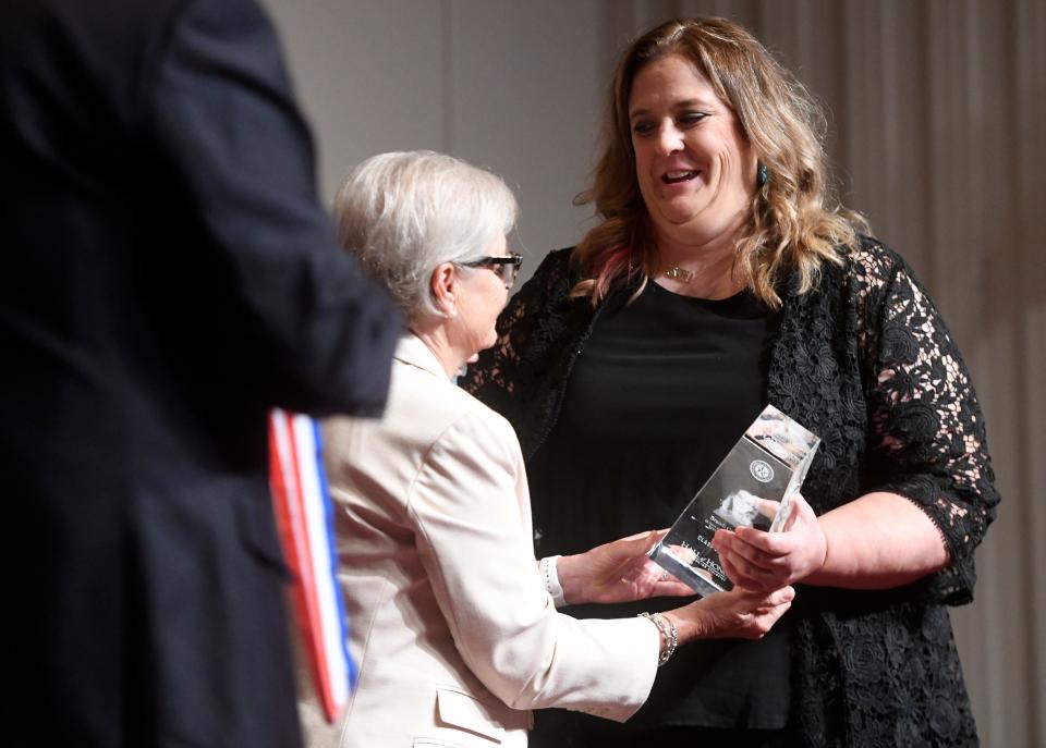 Brandi Cantrell, right, accepts her Hall of Honor award, Saturday, July 30, 2022, at Lubbock Memorial Civic Center. Cantrell was the volleyball coach at Coronado High School and currently is the Texas Tech women’s chaplain. 