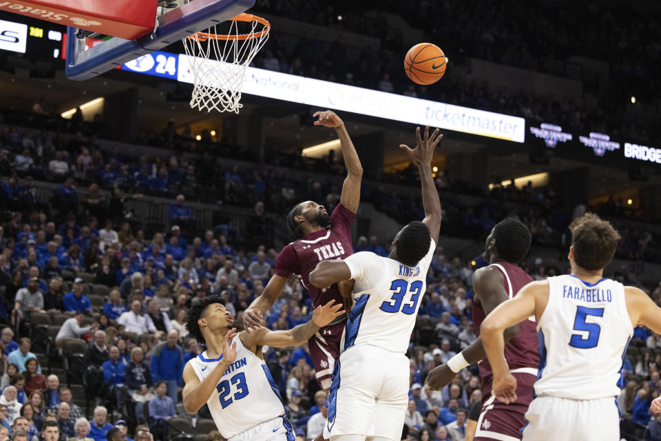 Texas Southern's Jonathan Cisse, second from left, reaches for a rebound against Creighton's Trey Alexander (23) and Fredrick King (33) during the first half of an NCAA college basketball game Saturday, Nov. 18, 2023, in Omaha, Neb. (AP Photo/Rebecca S. Gratz)