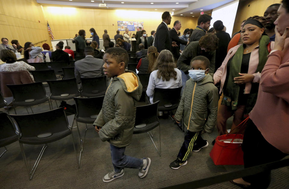 "Virtual school is not the answer," said mother Cheryl Lane, right, who leaves a Hazelwood School Board meeting with her two sons, Aaron, 9, left, and Andrew, 7, Tuesday, Oct. 18, 2022, at the Hazelwood School District Learning Center in Florissant, Mo. The board announced elementary students will switch to virtual learning after radioactive waste was found at Jana Elementary School. "My kids have been virtual since the start of the school year and they are not learning," said Lane. (Laurie Skrivan/St. Louis Post-Dispatch via AP)