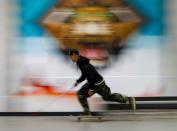 Blind Japanese skateboarder Ryusei Ouchi trains at a skatepark holding a cane, in Tokorozawa
