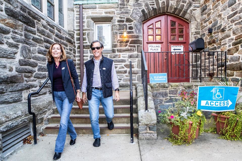 From left, Attorney General Kathy Jennings and her husband Dave White exit the voting site after casting their votes in the midterm elections at Immanuel Church Highlands in Wilmington, Tuesday, Nov. 8, 2022.