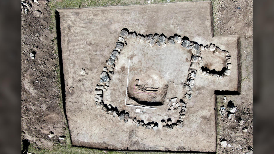 An aerial view of the charioteers burial, which is surrounded by a square perimeter of stones.
