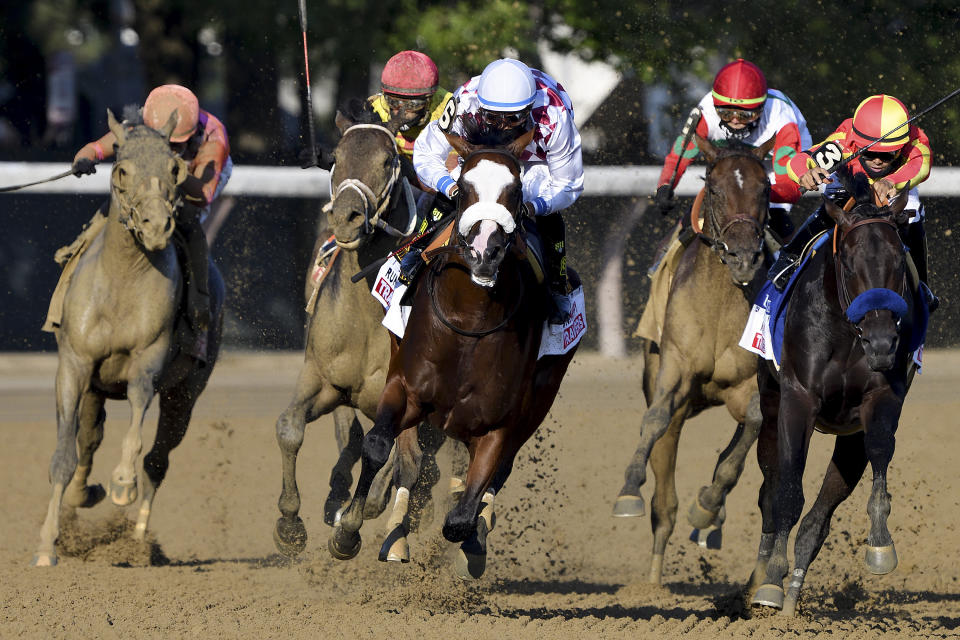 Tiz the Law, with Manny Franco up, center, leads the pack around the final turn on his way to win the Travers Stakes horse race at Saratoga, Saturday, Aug. 8, 2020, in Saratoga Springs, N.Y. (Elsa Lorieul/NYRA via AP)