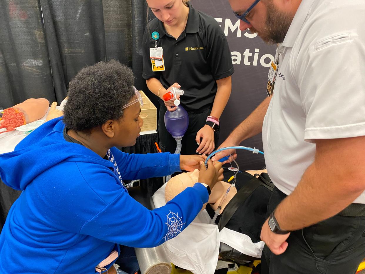 Jada Eckles, a junior at Hickman High School on Friday practices intubating a mannequin assisted by EMTs Paige Kovnesky and Stephen Dunkin at MU Health Care's Tomorrow's Healthcare Experts Expo at the Hilton Garden Inn & Conference Center.