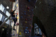 Audrey Grochowski wears a protective face mask while working out at Planet Granite climbing gym during the coronavirus pandemic in San Francisco, Thursday, March 4, 2021. The gym opened today to allow ten percent capacity. (AP Photo/Jeff Chiu)