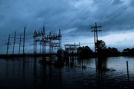 Flood waters from Tropical Storm Harvey surround a power sub-station in Iowa, Calcasieu Parish, Louisiana, U.S., on August 29, 2017. REUTERS/Jonathan Bachman