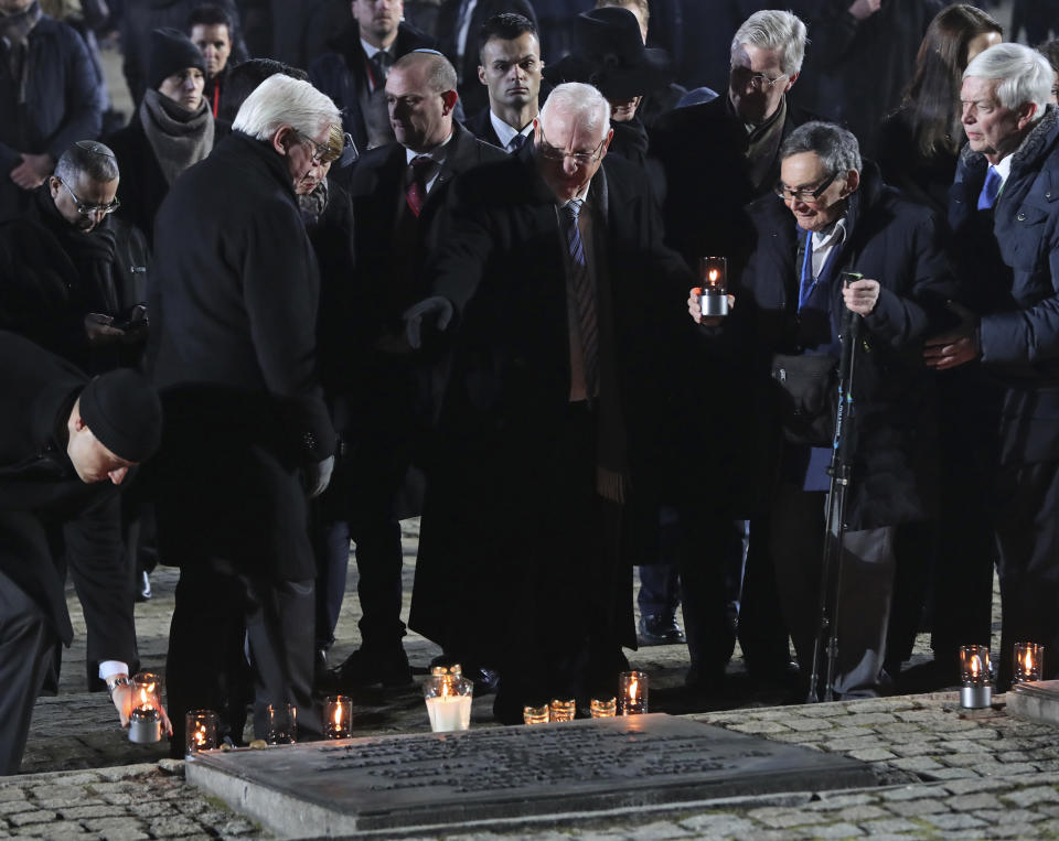 Germany's President Frank-Walter Steinmeier and his wife Elke Buedenbender, front row left, Israel's President Reuven Rivlin, center, and holocaust survivor Marian Turski, second right, attend commemorations at the Auschwitz Nazi death camp in Oswiecim, Poland, Monday, Jan. 27, 2020. Survivors of the Auschwitz-Birkenau death camp gathered for commemorations marking the 75th anniversary of the Soviet army's liberation of the camp, using the testimony of survivors to warn about the signs of rising anti-Semitism and hatred in the world today. (AP Photo/Czarek Sokolowski)