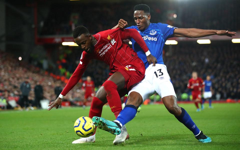 Divock Origi of Liverpool battles for possession with Yerry Mina of Everton during the Premier League match between Liverpool FC and Everton FC at Anfield on December 04, 2019 in Liverpool, United Kingdom - Getty Images