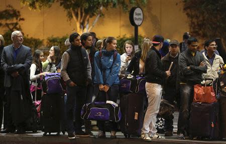 Travelers wait for transportation at Los Angeles International Airport November 22, 2013. REUTERS/Jonathan Alcorn