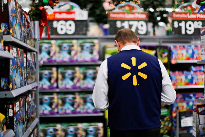 FILE PHOTO: A Walmart worker organises products for Christmas season at a Walmart store in Teterboro