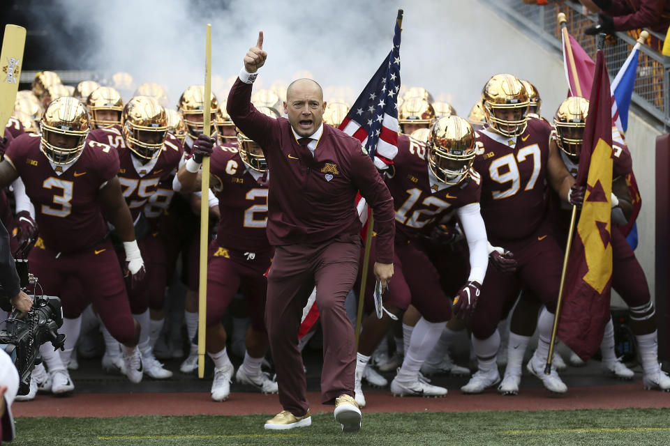 Minnesota head coach P.J. Fleck leads him team onto the field prior to the start of an NCAA college football game. (AP)