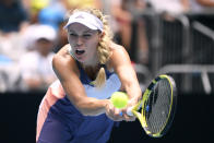 Denmark's Caroline Wozniacki makes a backhand return to Tunisia's Ons Jabeur in their third round singles match at the Australian Open tennis championship in Melbourne, Australia, Friday, Jan. 24, 2020. (AP Photo/Andy Brownbill)