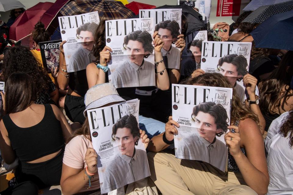 Fans greeted Chalamet with pictures of his face, seemingly on the front of Elle magazine (Vianney Le Caer/Invision/AP) (AP)