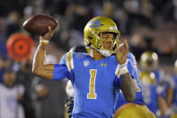 FILE - In this Nov. 30, 2019 file photo, UCLA quarterback Dorian Thompson-Robinson passes during the second half of an NCAA college football game against California in Pasadena, Calif. He is returning for this third season as quarterback (AP Photo/Mark J. Terrill, File)