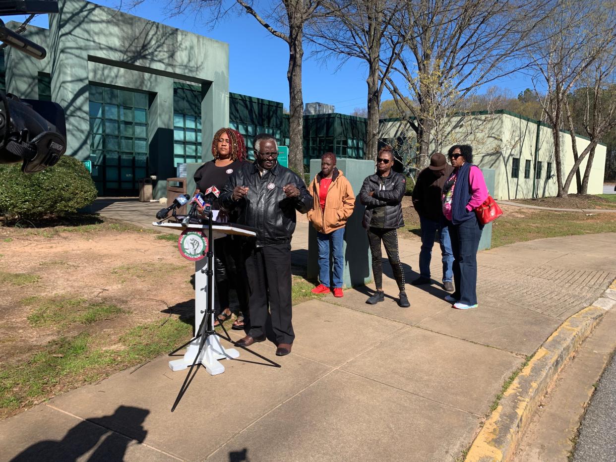 President Dr. Candace Brewer (L) and CEO Elder James Johnson (R) of the Racial Justice Network, a South Carolina civil rights group, speak at a press conference outside the Spartanburg County Detention Facility on March 15, 2023. Behind them stands the family of Darius Holcomb, who was killed in an officer-involved shooting with the Spartanburg County Sheriff's Office on February 2, 2023.