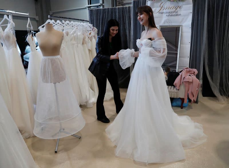 A woman tries on a wedding dress during the Central European Wedding Show in Budapest