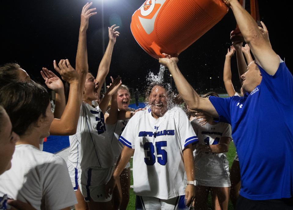 Sophia Dapper, a goalie for the Community School of Naples Lacrosse team is doused after a win over Naples during a district game at at CSN on Thursday, April 18, 2024.