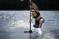 Canoe sprint world champion Nevin Harrison, 19, of Seattle, trains near Lake Lanier Olympic Park on Thursday, July 1, 2021, in Gainesville, Ga. Harrison won the world championship in the women's sprint canoe 200 meters as a 17-year-old in 2019. Now she'll try to duplicate that at the Olympics in Tokyo where the race will be a new event in a bid for gender equity. (AP Photo/Brynn Anderson)