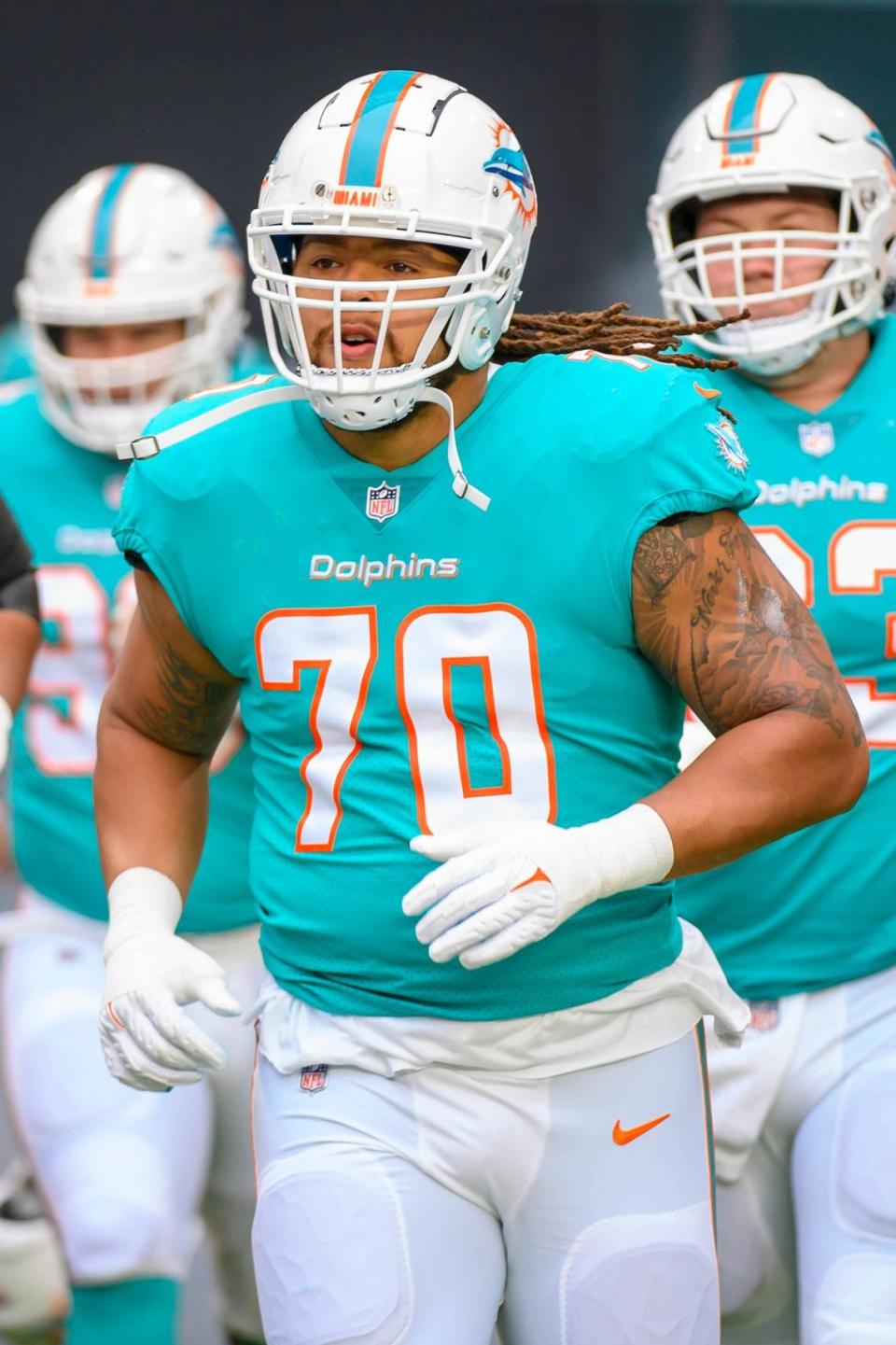 Miami Dolphins tackle Kendall Lamm (70) runs onto the field before an NFL football game against the Green Bay Packers, Sunday, Dec. 25, 2022, in Miami Gardens, Fla. (AP Photo/Doug Murray)