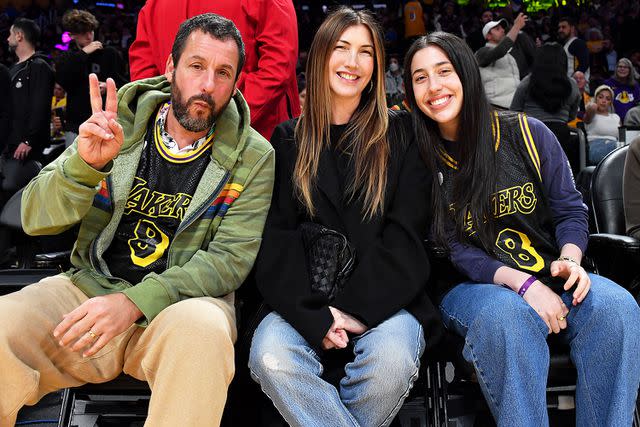 <p>Allen Berezovsky/Getty</p> Adam, Jackie and Sadie Sandler at a 2024 Lakers game