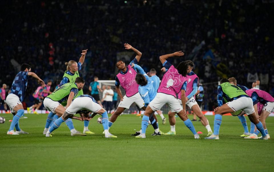 Manchester City players warm up - AP Photo/Emrah Gurel