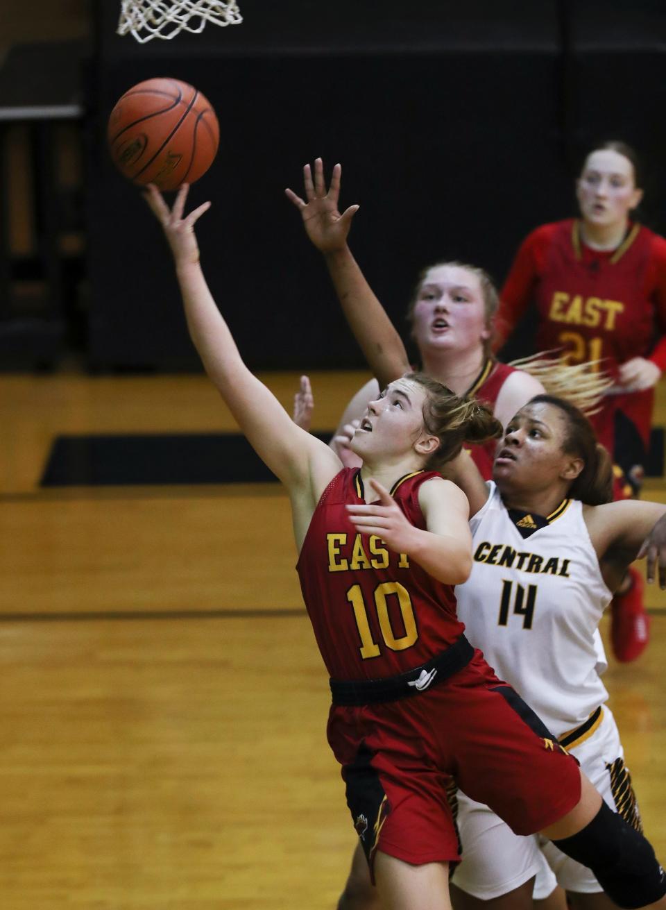 Bullitt East's Emma Egan (10) beats Central's Briontanay Marshall (14) to the basket during their game at the Central High School in Louisville, Ky. on Jan. 11, 2022.  Bullitt East won 63-52.