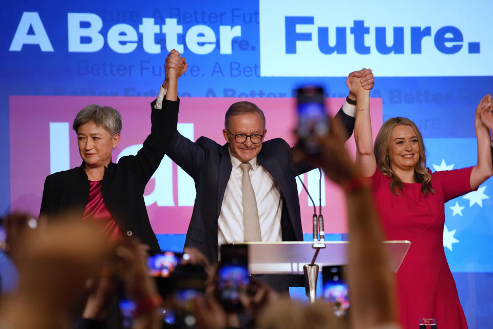 Labor Party leader Anthony Albanese, center back, celebrates with his partner partner Jodie Haydon, right, and Labor senate leader partner Penny Wong at a Labor Party event in Sydney, Australia, Sunday, May 22, 2022, after Prime Minister Scott Morrison conceding defeat to Albanese in a federal election. (AP Photo/Rick Rycroft)