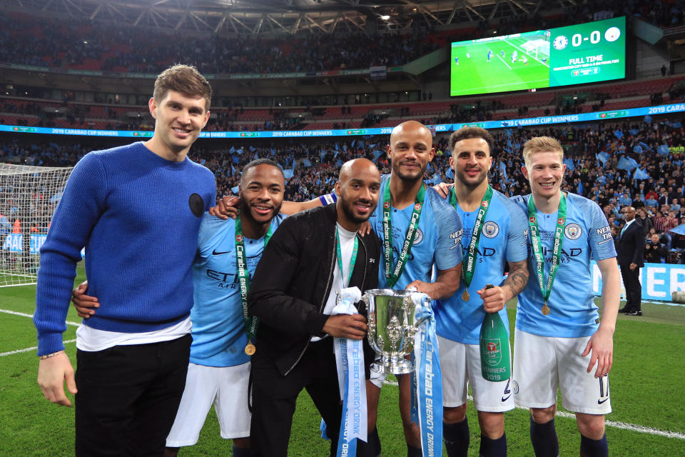 LONDON, ENGLAND - FEBRUARY 24:  John Stones, Raheem Sterling, Fabian Delph, Vincent Kompany, Kyle Walker and Kevin De Bruyne of Manchester City celebrate victory with the trophy after the Carabao Cup Final between Chelsea and Manchester City at Wembley Stadium on February 24, 2019 in London, England.  (Photo by Victoria Haydn/Man City via Getty Images)