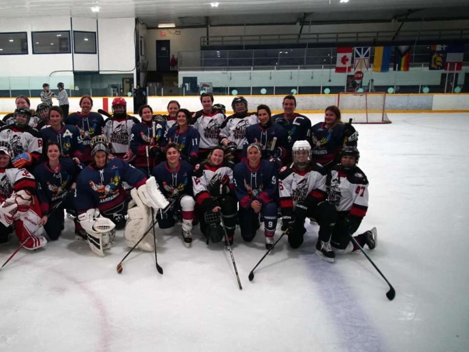 Players from St-Pierre-Miquelon and the St. John's area come together for a picture after a game on Saturday morning at Capital Hyundai Arena. (Ryan Cooke/CBC - image credit)