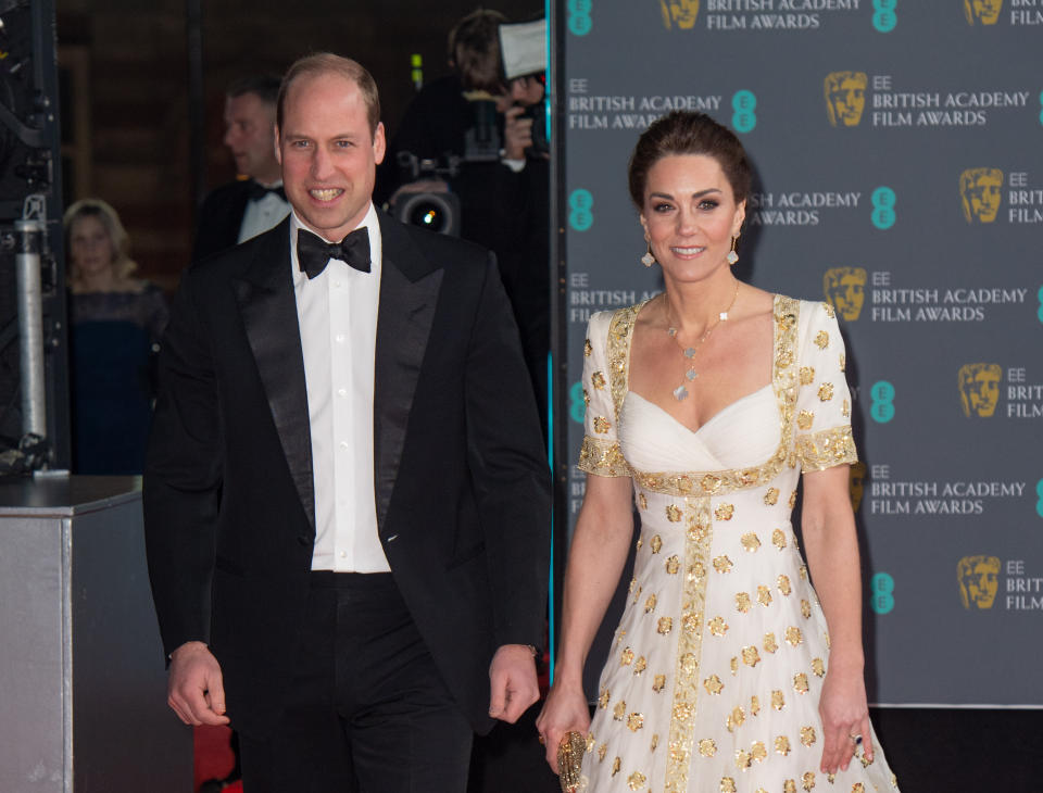 The Duke of Cambridge, President of BAFTA,  and The Duchess of Cambridge wearing a full-length white and gold gown by Alexander McQueen, arrive at the 2020 BAFTA Awards Ceremony at the Royal Albert Hall in London on February 02, 2020.