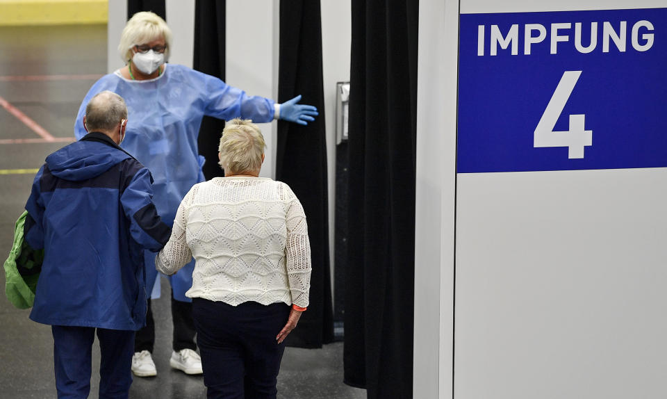 People are on their way to their vaccination at the vaccination center in Gelsenkirchen, Germany, Monday, April 26, 2021. Germany's COVID-19 vaccination program will be discussed at a meeting with Germany's state Governors and Chancellor Angela Merkel in Berlin today. (AP Photo/Martin Meissner)