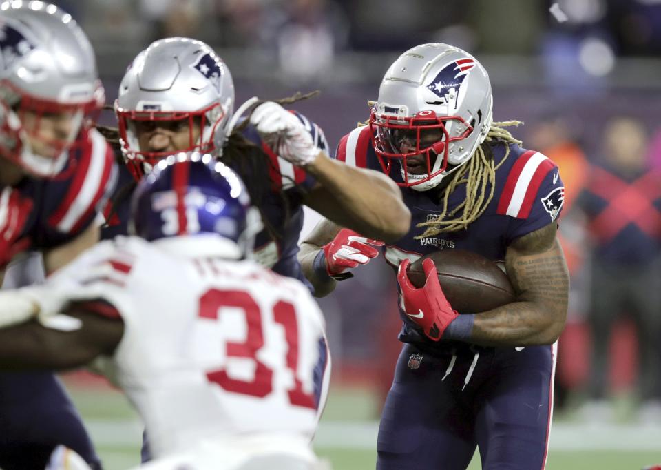 New England Patriots running back Brandon Bolden, right, follows his blockers into the end zone for a touchdown against the New York Giants in the first half of an NFL football game, Thursday, Oct. 10, 2019, in Foxborough, Mass. (AP Photo/Charles Krupa)