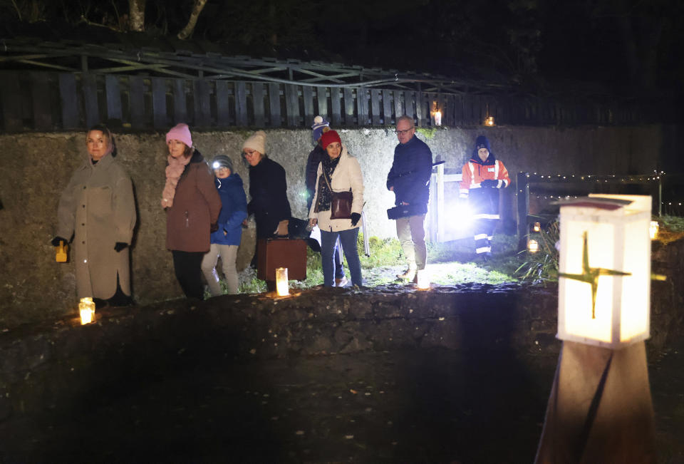 People participate in a candlelight pilgrimage walk which makes its way past an ancient well associated with St Brigid to the Solas Bhride Centre in Kildare, Ireland, Tuesday, Jan. 31, 2023. (AP Photo/Peter Morrison)