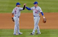 October 9, 2015; Los Angeles, CA, USA; New York Mets shortstop Ruben Tejada (11) celebrates with second baseman Kelly Johnson (55) the 3-1 victory against the Los Angeles Dodgers in game one of the NLDS at Dodger Stadium. Mandatory Credit: Jayne Kamin-Oncea-USA TODAY Sports