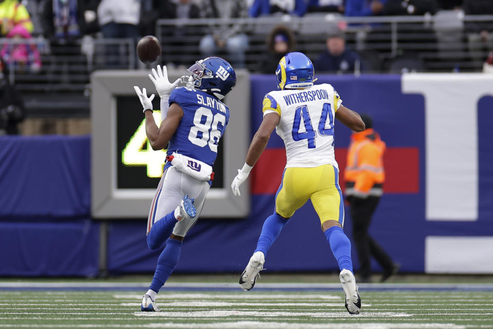 New York Giants wide receiver Darius Slayton (86) catches a touchdown pass against Los Angeles Rams cornerback Ahkello Witherspoon (44) during the second half an NFL football game, Sunday, Dec. 31, 2023, in East Rutherford, N.J. (AP Photo/Adam Hunger)